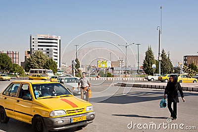 Asian man and woman trying to catch taxi cab on the busy road