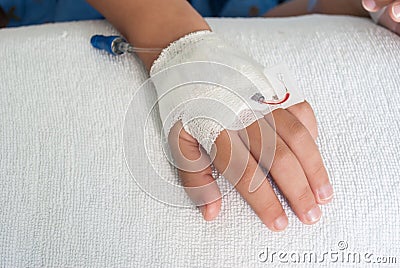 Asian patient boy hand with saline intravenous (iv) on hospital