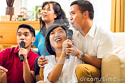 Asian people singing at karaoke party