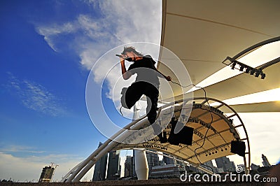 Asian Rock Star performing with city as backdrop