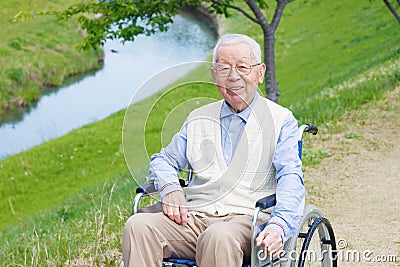 Asian senior man sitting on a wheelchair