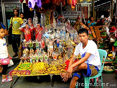 Asian street vendor selling different religious items outside of quiapo church in quiapo, manila, philippines in asia