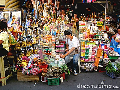 Asian street vendor selling different religious items outside of quiapo church in quiapo, manila, philippines in asia