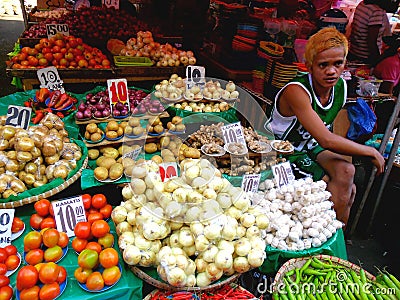 Asian street vendor selling fruits and vegetable in quiapo, manila, philippines in asia