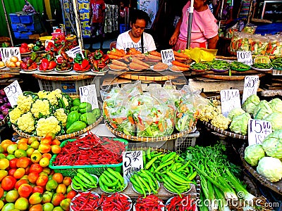 Asian street vendor selling fruits and vegetable in quiapo, manila, philippines in asia