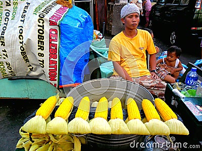 Asian street vendor selling steamed corn on a cob in quiapo, manila, philippines in asia