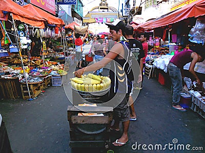 Asian street vendor selling steamed corn on a cob in quiapo, manila, philippines in asia