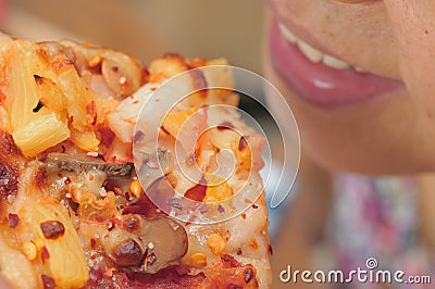 Asian woman eating pizza