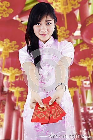 Asian woman holding red packet gift