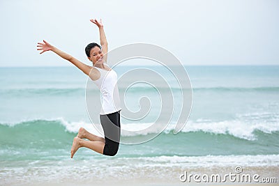 Asian woman jump on beach.