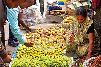 Asian woman sell fruits on the crowd market