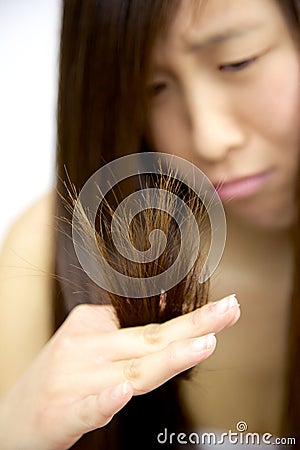 Asian woman unhappy about split ends hair