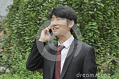 Asian young businessman on a cell phone
