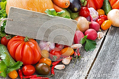 Assorted fresh seasonal vegetables with wooden nameplate