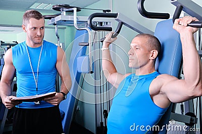 Athlete man with personal fitness trainer