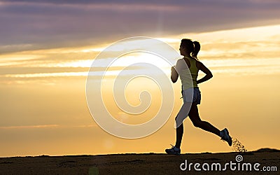 Athlete running at sunset on beach