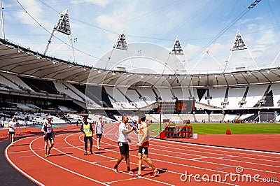 Athletes shaking hands in olympic stadium