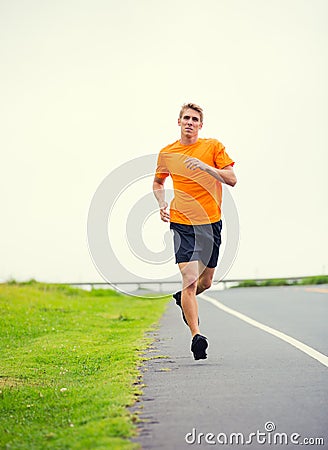 Athletic man running outside, training outdoors