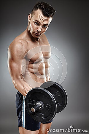 Athletic man working out with dumbbells