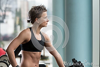 Athletic Woman Workout With Weights In The Gym