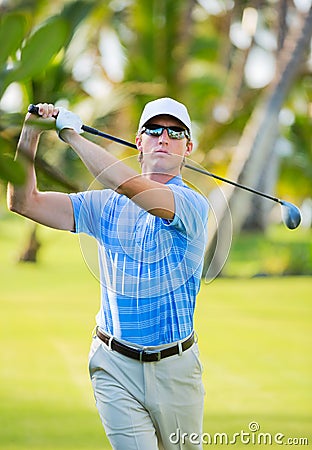 Athletic young man playing golf