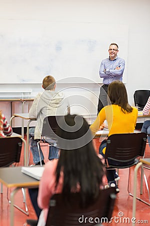 Attentive students with teacher in the classroom