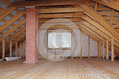 Attic with chimney in wooden house under construction overall view