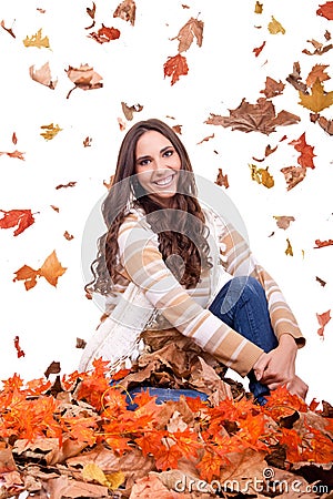 Attractive autumn woman and falling leaves