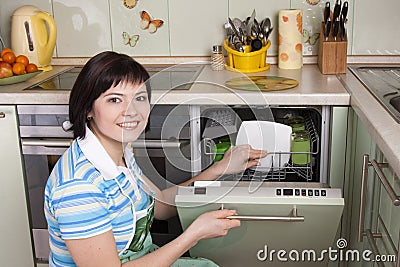 Attractive brunette woman cleaning kitchen