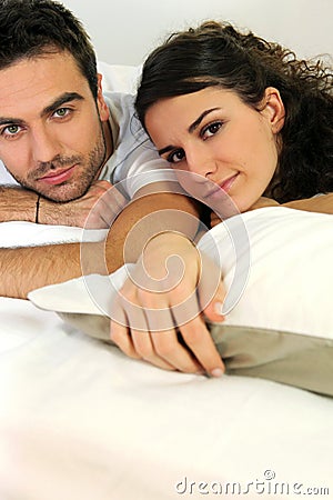 Attractive couple lying in bed