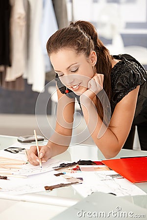 Attractive fashion designer working in office