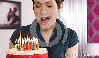 Attractive Female Readies to Blow Out Birthday Cake Candles