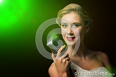 Attractive female singer with microphone