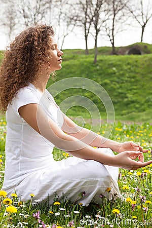 Attractive girl in one of the yoga postures close up