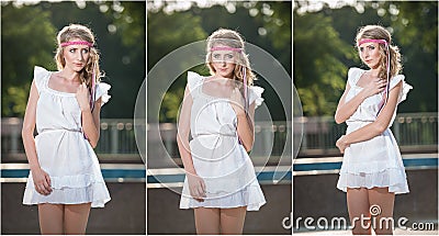 Attractive girl in white short dress sitting near the fountain in the summer hottest day