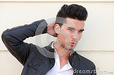Attractive male fashion model with hand in hair