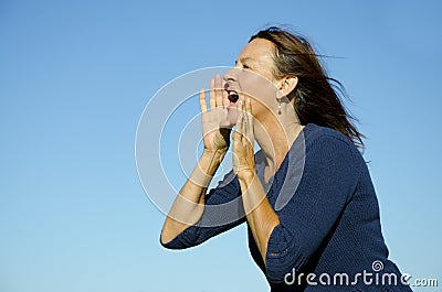 Attractive mature woman shouting out loud