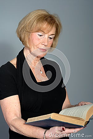 Attractive older woman reading book