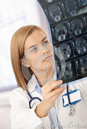 Attractive radiologist analysing x-ray image