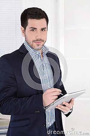 Attractive successful manager with digital tablet at office.
