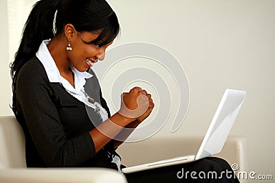 Attractive woman on black suit with a laptop