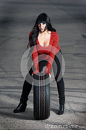 Attractive woman with car tire