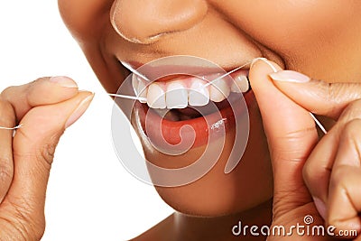 Attractive woman with dental floss. Closeup.