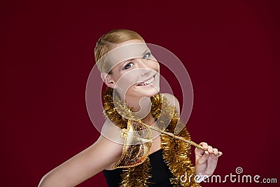 Attractive woman with masquerade mask and tinsel