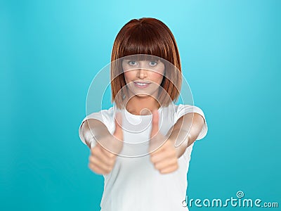 Attractive woman smiling with her thumbs up