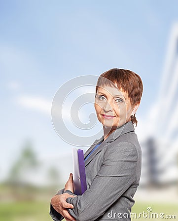 Attractive woman 50 years old with a folder