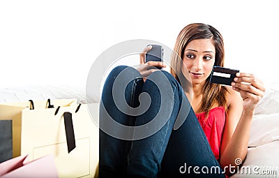 Attractive young asian indian woman shopping online