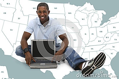 Attractive Young Man Sitting On Floor with Laptop Computer