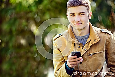 Attractive young man using a mobile phone