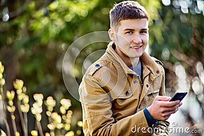 Attractive young man using a mobile phone